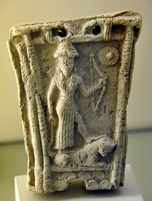 Ishtar stands on a lion and holds a bow god Shamash from Southern Mesopotamia Iraq.jpg